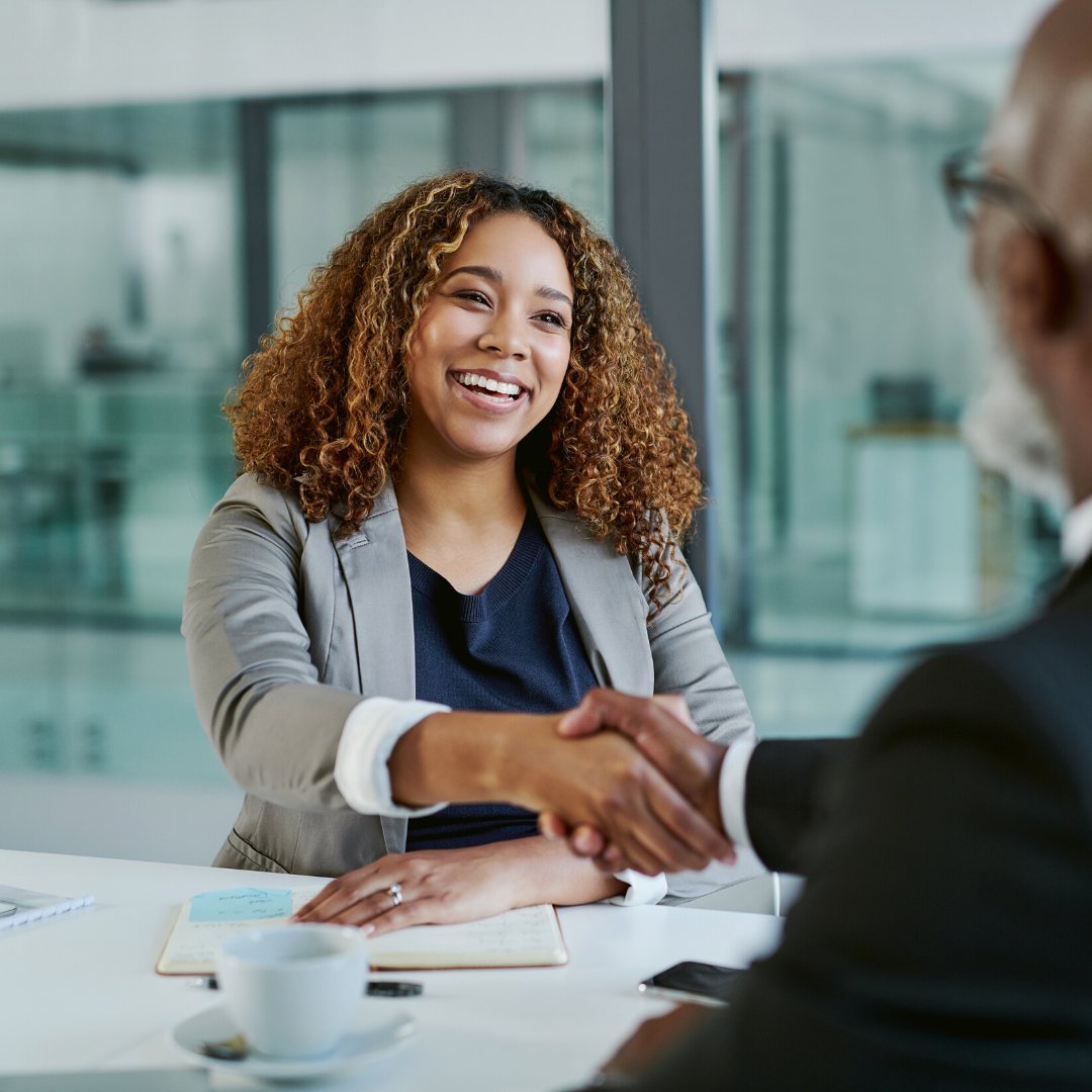 black woman shake hands on work