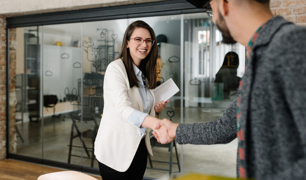 Openly greeting a job recruiter with a firm handshake